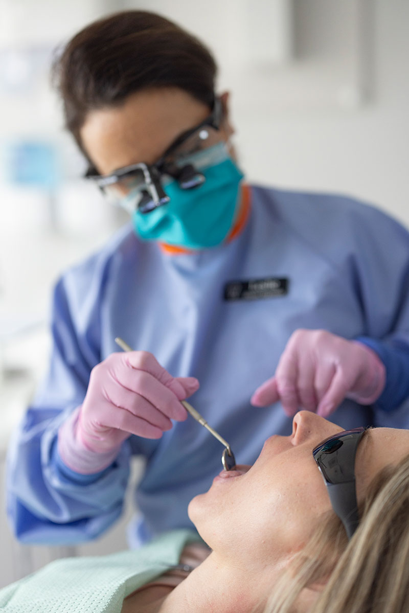 Woman getting dental exam from Dr. Geelan, DMD in Portland